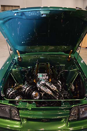 Race engine with twin turbos in forest green colored Mustang