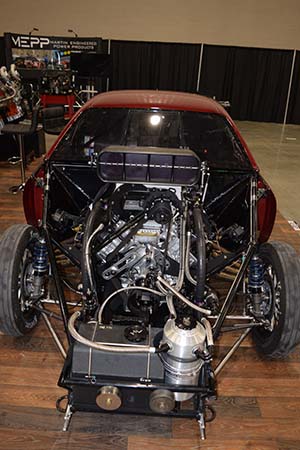 Front view of race engine installed in dark red car