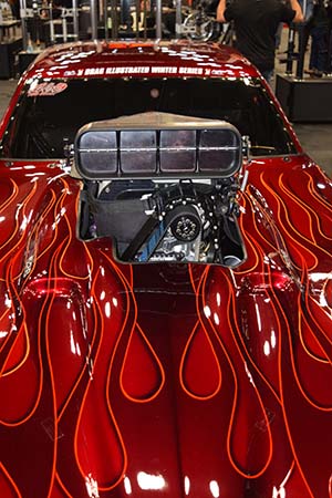 Supercharger installed in red car with flame decals