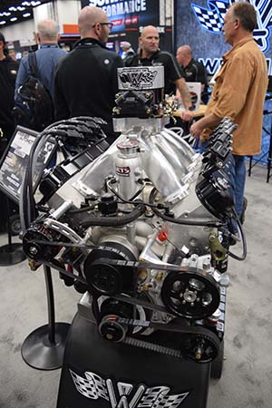 Engine with belts, pulleys, and intake manifold on stand