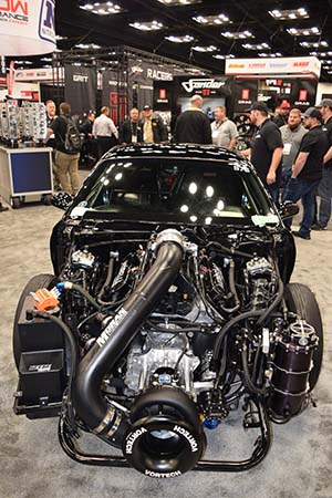 Race engine with Vortech supercharger in front with Moran Racing Engines label in black car