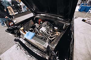 Race car engine with intake manifold and carburetor installed in black car