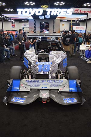 Gray and blue race car with 18 on hood and rear wing