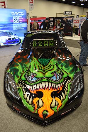 Drag car with green monster graphic on hood spewing flames and Bamm Bamm on intakes