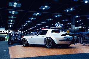 White classic Chevrolet Corvette with black wing on back