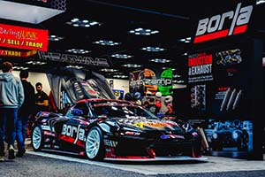 Black C8 Corvette with Borla decal on side in Borla booth