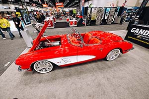 Red and white classic Corvette with hood open