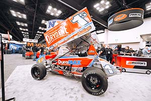 Orange and gray winged sprint car with Drydene and 1S on wing