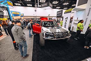 White and red race truck with doors open and no hood