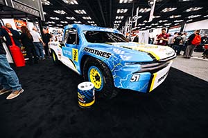 Blue and white race truck with Bilstein and Toyo Tires decals on side and Sunoco fuel can in front 