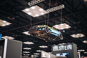 Mercedes-Benz race car with Bilstein logo hanging from ceiling with tethers attached to wheels