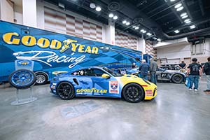 Blue and yellow Porsche race car with Goodyear logo