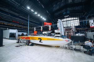 White and yellow race boat with 2 on side