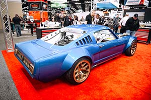 Blue classic Mustang with black fuel tank in back seat