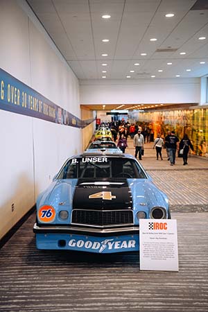 Light blue IROC Camaro with Goodyear logo underneath bumper and 4 on hood