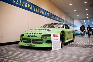 Green Firebird race car with IROC sign in front