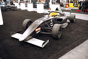 Carbon fiber formula car on black carpet