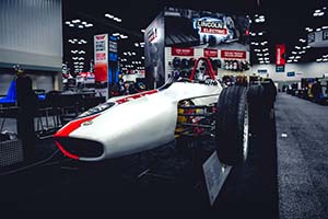 Vintage white and red race car elevated on stand