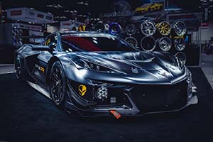 Flat black Chevrolet Corvette with wheels on display in background