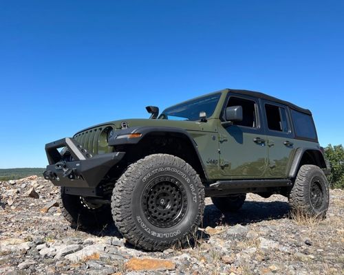 Quadratec Jeep Wrangler parked offroad on gravel