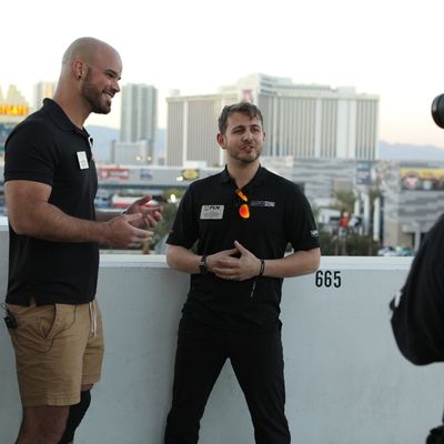 Two men being interviewed with Las Vegas skyline in the background